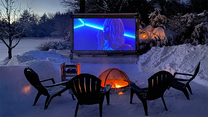 Atomic Blonde movie playing on a Timberline Outdoor Movie Theater during the winter.